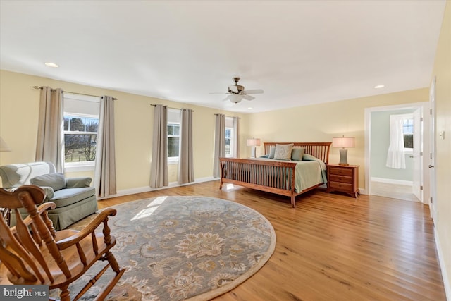 bedroom with a ceiling fan, recessed lighting, light wood-style floors, and baseboards