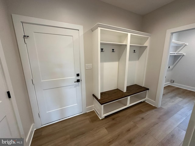 mudroom with baseboards and wood finished floors