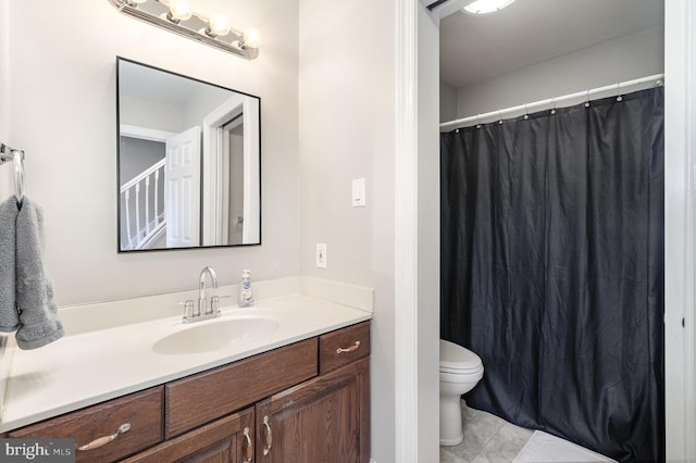 bathroom with curtained shower, vanity, and toilet