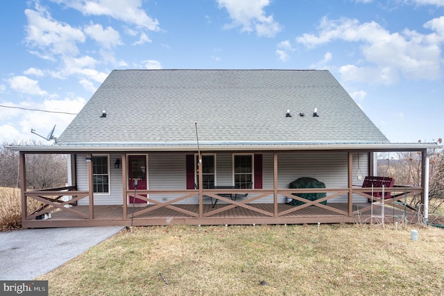 rear view of house with a shingled roof and a wooden deck