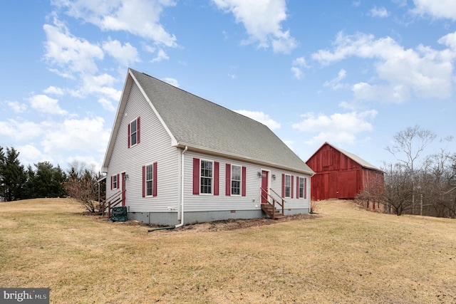 view of front of home featuring entry steps, crawl space, a front yard, and a barn