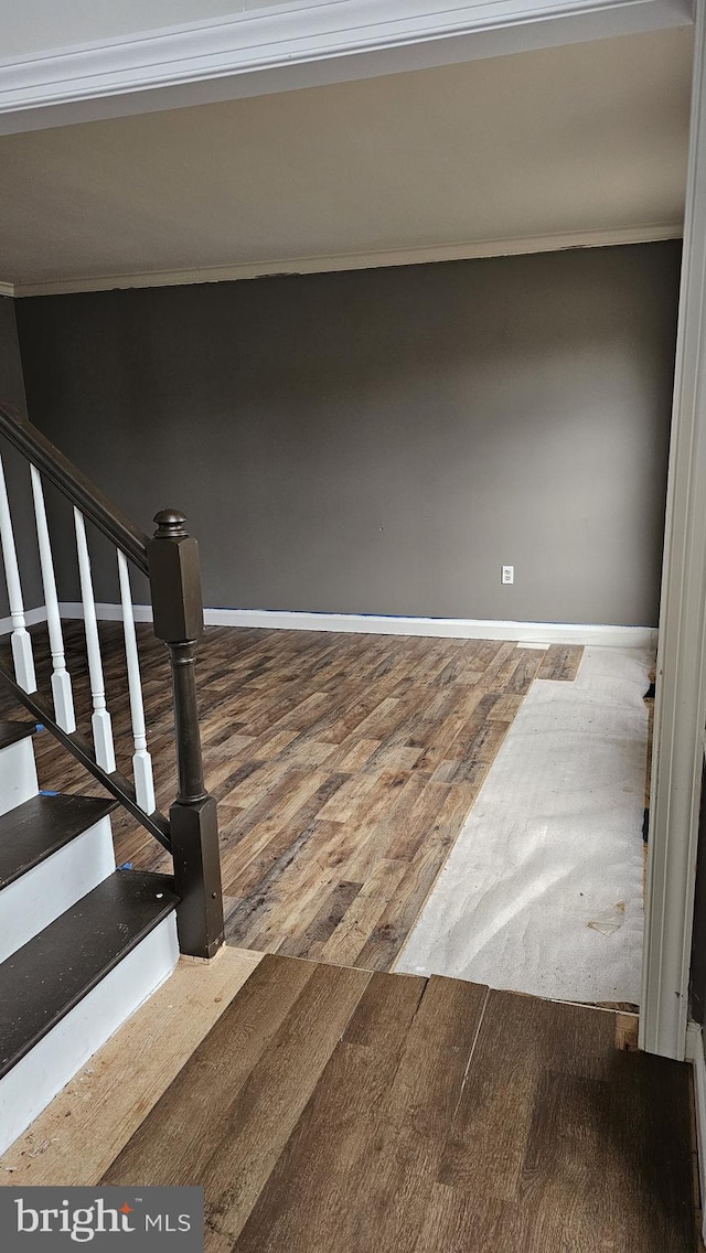 interior space with wood finished floors and baseboards