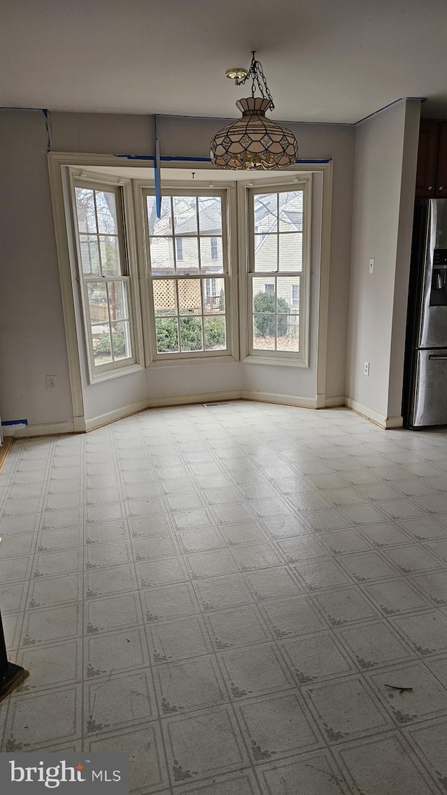 interior space with a healthy amount of sunlight, baseboards, and tile patterned floors