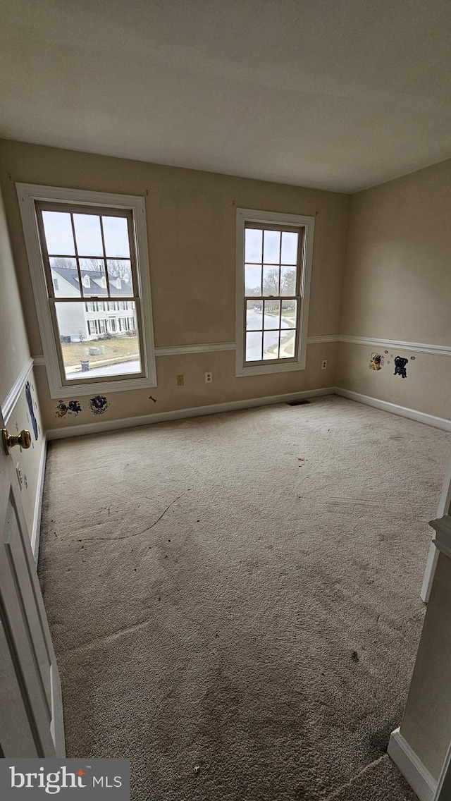 spare room with carpet floors and baseboards