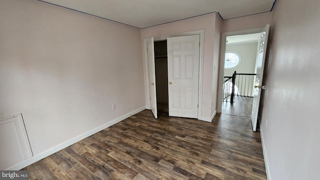 unfurnished bedroom featuring dark wood finished floors and baseboards