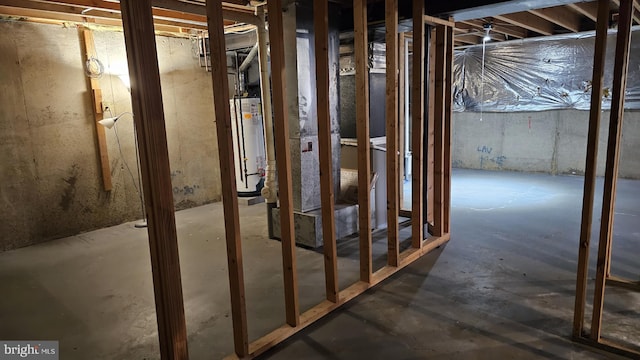 interior space featuring gas water heater and unfinished concrete floors