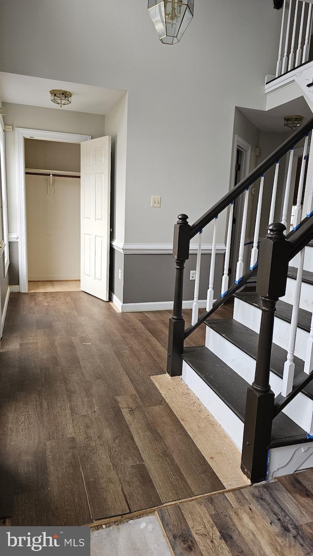 stairway with baseboards and wood finished floors