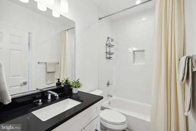 full bath featuring shower / bath combo with shower curtain, toilet, and vanity