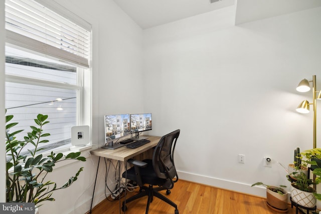 home office featuring baseboards and light wood finished floors