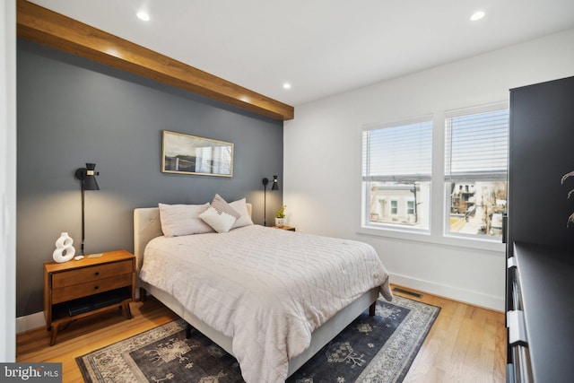 bedroom featuring beamed ceiling, recessed lighting, light wood-style flooring, and baseboards