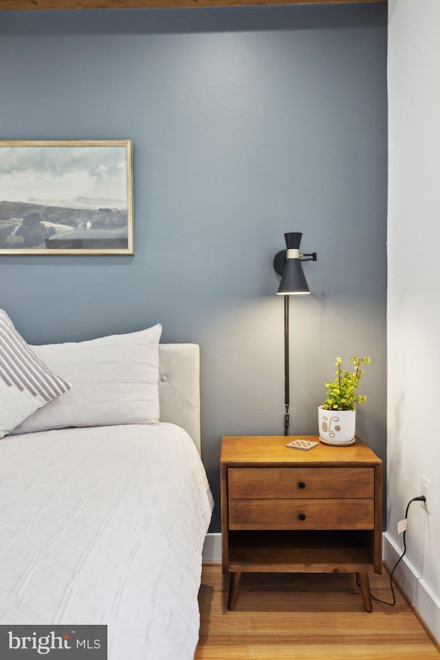 bedroom featuring wood finished floors and baseboards