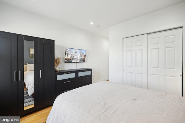 bedroom with recessed lighting, a closet, and light wood finished floors