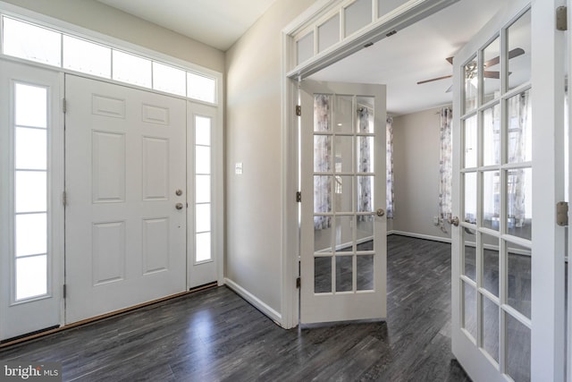 foyer featuring french doors, baseboards, and wood finished floors