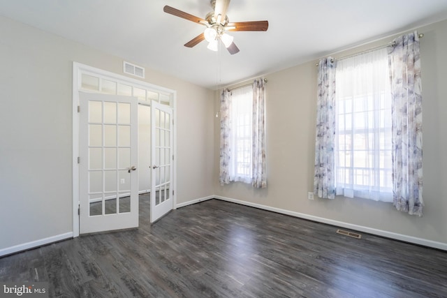 unfurnished room featuring visible vents, ceiling fan, baseboards, and wood finished floors