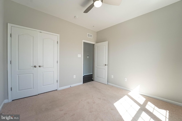 unfurnished bedroom with visible vents, a ceiling fan, a closet, carpet, and baseboards