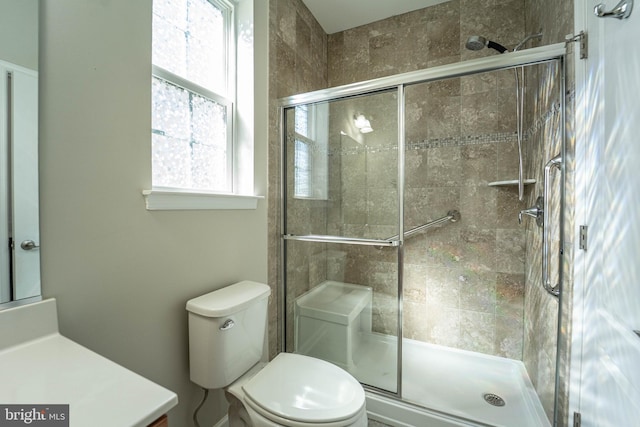 bathroom with a stall shower and toilet