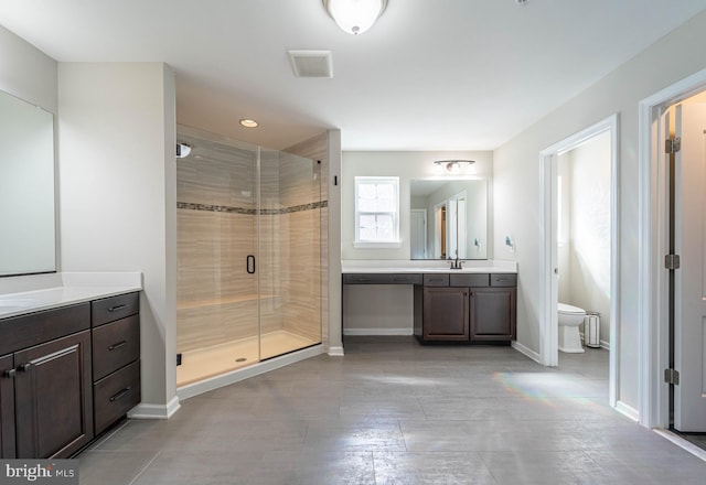 full bath featuring visible vents, baseboards, a stall shower, and a sink