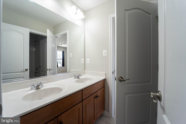 bathroom featuring a sink, double vanity, and tile patterned flooring