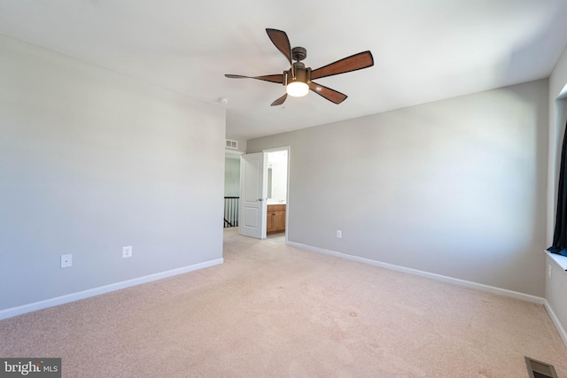 unfurnished bedroom with visible vents, baseboards, and light colored carpet