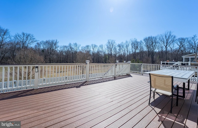 wooden deck featuring outdoor dining area