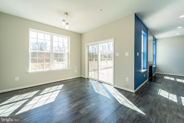 interior space featuring dark wood finished floors, visible vents, and baseboards