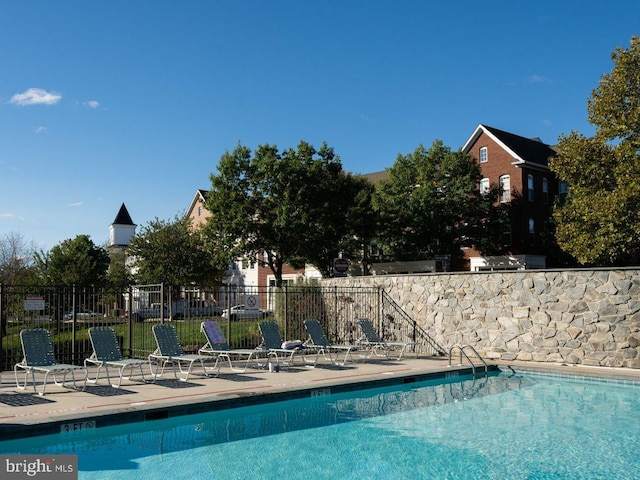 pool featuring a patio and fence