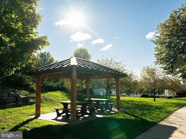 surrounding community with a lawn and a gazebo