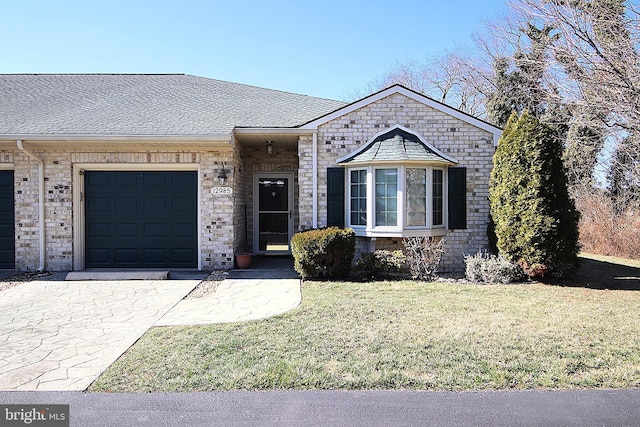 view of front facade with a garage, a shingled roof, and a front lawn