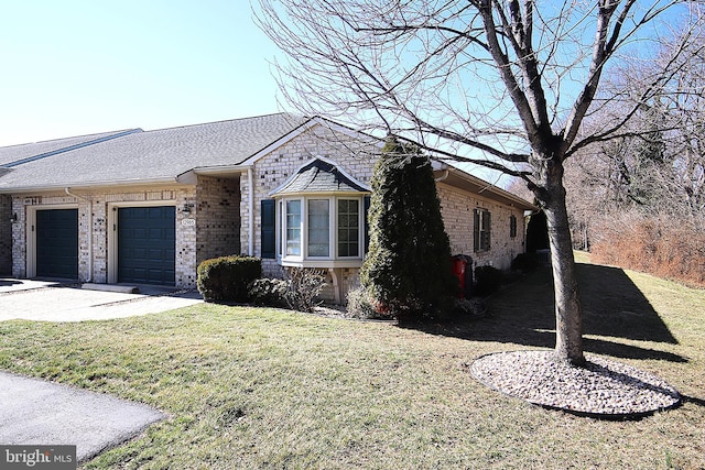 view of front of house with a garage, a shingled roof, a front lawn, and brick siding