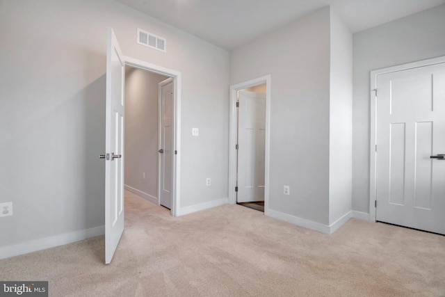 unfurnished bedroom featuring baseboards, visible vents, and carpet floors