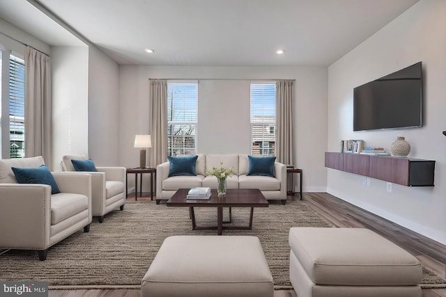 living room featuring recessed lighting, baseboards, and wood finished floors