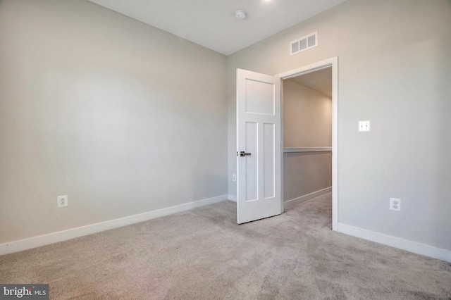 unfurnished bedroom with visible vents, carpet floors, and baseboards