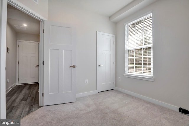 unfurnished bedroom with baseboards and carpet floors