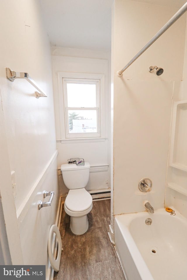 full bathroom with a baseboard heating unit, shower / bathing tub combination, wood finished floors, and toilet