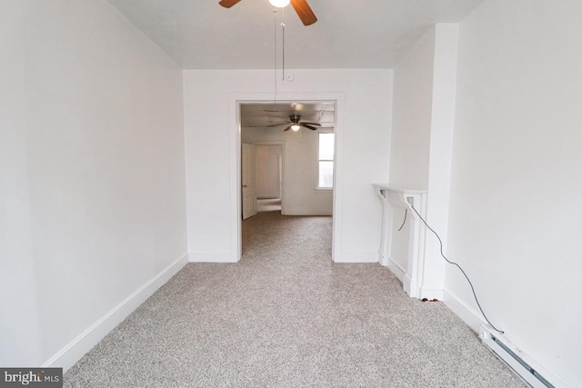 carpeted spare room featuring baseboards