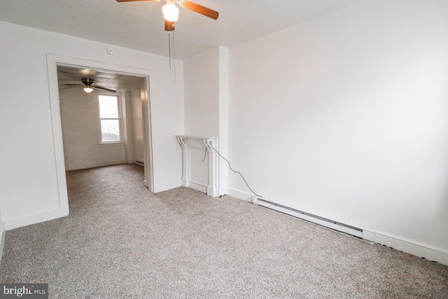 spare room with a baseboard radiator, carpet flooring, and baseboards