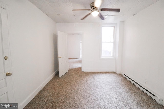 unfurnished bedroom with a baseboard radiator, carpet flooring, ceiling fan, and baseboards