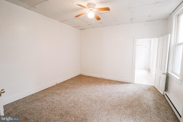 unfurnished room featuring baseboards, baseboard heating, a ceiling fan, and light colored carpet