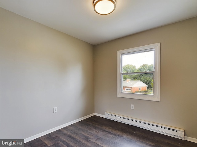 unfurnished room with dark wood-type flooring, baseboard heating, and baseboards