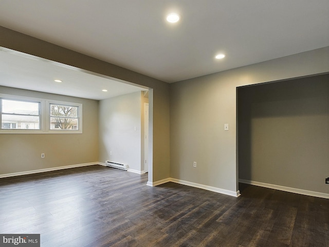 interior space with dark wood-style floors, baseboards, a baseboard heating unit, and recessed lighting