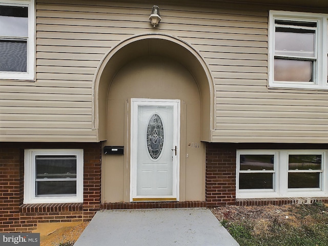 property entrance with brick siding