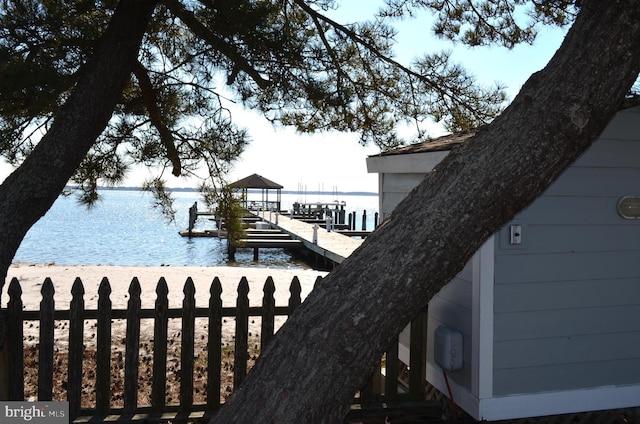 dock area with a water view and boat lift