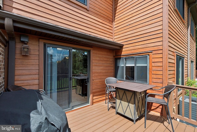 wooden terrace featuring outdoor dining space