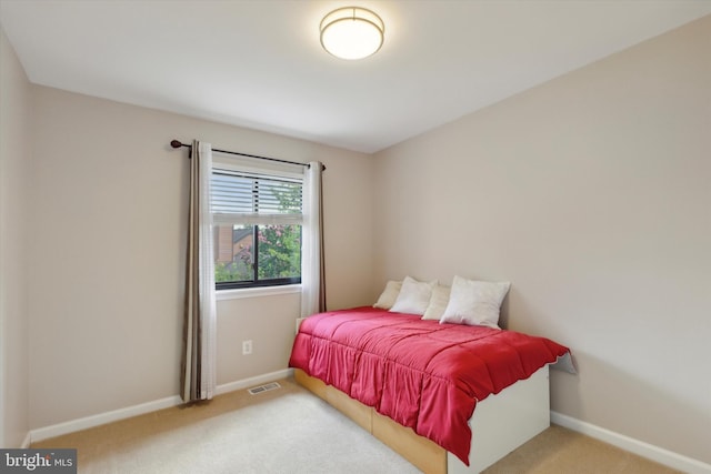 carpeted bedroom with visible vents and baseboards