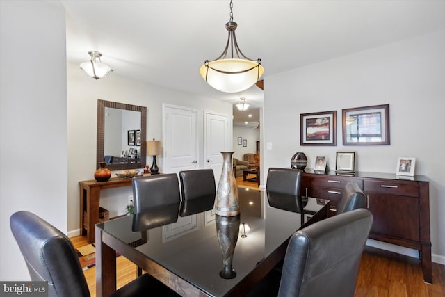 dining room with wood finished floors and baseboards