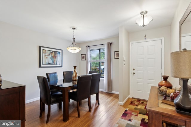 dining room featuring baseboards and wood finished floors