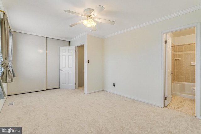 unfurnished bedroom featuring visible vents, connected bathroom, ornamental molding, carpet floors, and a closet