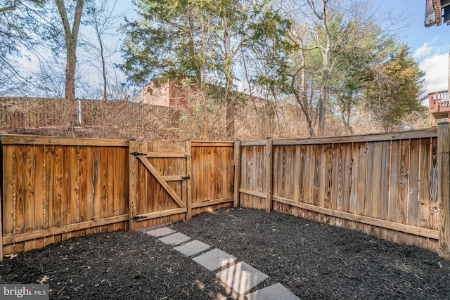 view of yard featuring fence and a gate