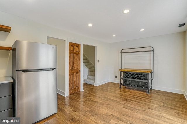 kitchen with baseboards, open shelves, light wood-style flooring, recessed lighting, and freestanding refrigerator