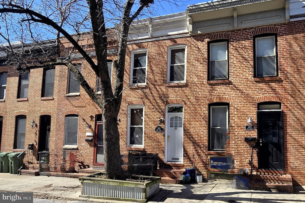 townhome / multi-family property with brick siding and entry steps